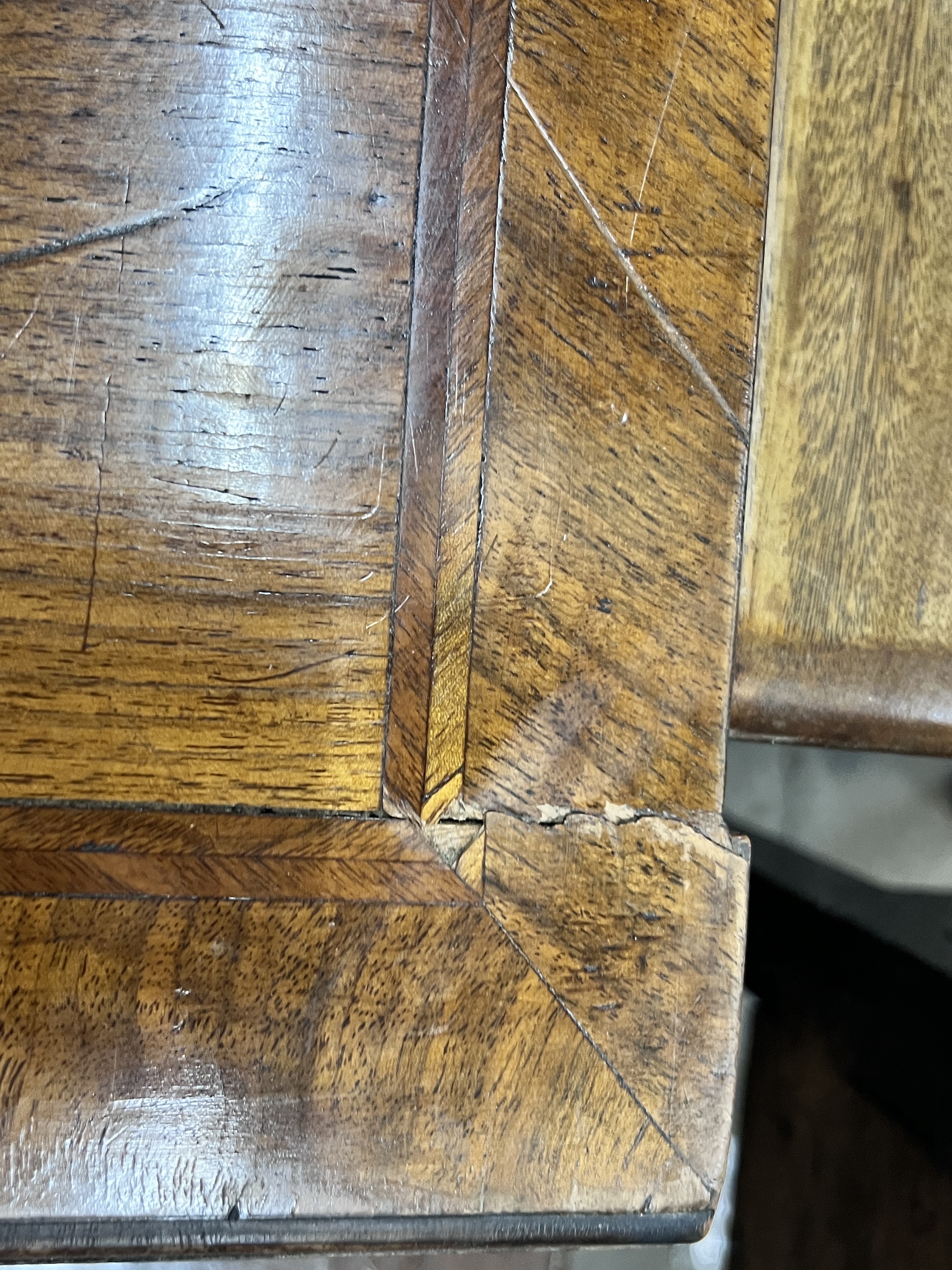 A Queen Anne revival feather banded walnut kneehole dressing table, width 129cm, depth 58cm, height 78cm